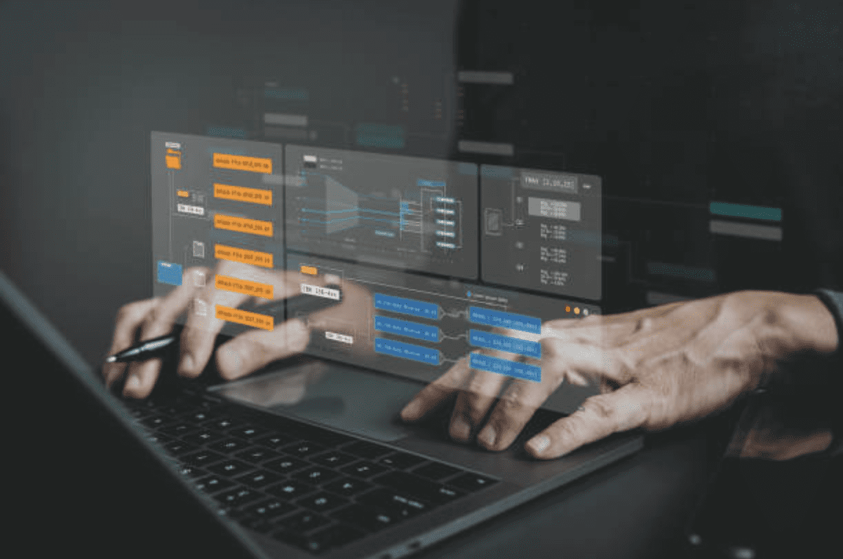 A person engaged with a laptop, which shows a graph on its screen for data interpretation